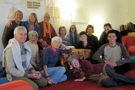 Historic Muz Murray mantra workshop photo showing a small satsang-style gathering in a home setting.